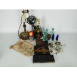 Two converted oil lamps, vintage bottles, printer's blocks, door handles and similar.