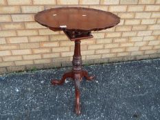 A tilt top occasional table approximately 78 cm x 60 cm