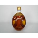 A vintage bottle of Dimple blended Scotch whisky with wire wrapping, no strength or capacity stated.