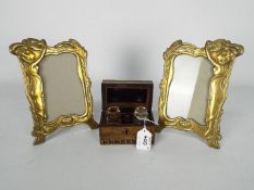 A pair of Art Nouveau style brass photograph frames (21.5 cm height) and a travelling inkwell set.