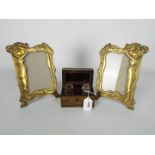 A pair of Art Nouveau style brass photograph frames (21.5 cm height) and a travelling inkwell set.