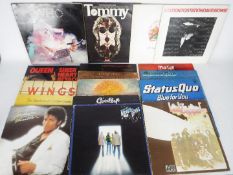 A collection of 12" vinyl records to include The Who, Led Zeppelin, Meat Loaf, Status Quo, Queen,