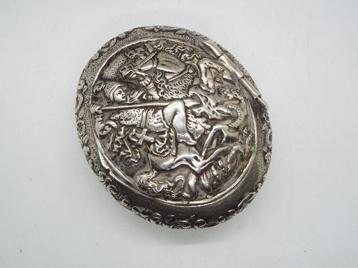 A continental white metal snuff box of oval form, stamped 800,