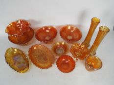 Carnival Glass - A collection of orange Carnival Glass to include several fluted bowls,