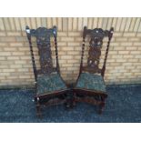 Two chairs with carved decoration and upholstered seats.