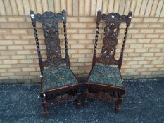 Two chairs with carved decoration and upholstered seats.