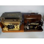 Two vintage sewing machines comprising a Singer and a Jones, both contained in carry cases.