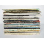 A quantity of 12" vinyl records to include Elton John, George Harrison, The Beatles, Beach Boys,