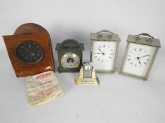 A Selection of clocks to include a Smiths (for restoration) and two Metamec clocks,