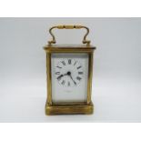 An early 20th century French brass and glass cased carriage clock,