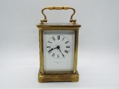 An early 20th century French brass and glass cased carriage clock,