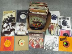 A collection of 7" vinyl records to include The Rolling Stones, The Beatles, The Animals, Bob Dylan,