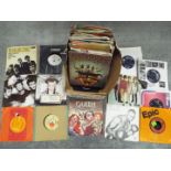 A collection of 7" vinyl records to include The Rolling Stones, The Beatles, The Animals, Bob Dylan,