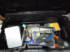 A large, hard case containing a quantity of tools, clamps, accessory organisers and similar.