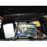 A large, hard case containing a quantity of tools, clamps, accessory organisers and similar.