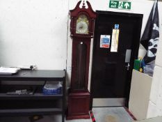 A modern Tempus Fugit longcase clock with pendulum and three weights, approximately 211 cm (h).