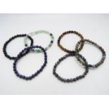 A Lapiz Lazuli Multicolour fluorite and black agate set of 6 stretchable bracelets.