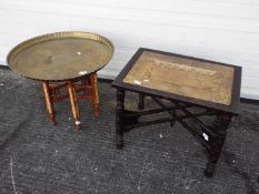 A Benares style table with 66 cm (d) brass top and folding six leg support and one similar with