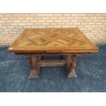 A good quality extending dining table with carved detailing and turned supports,