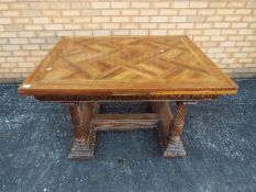 A good quality extending dining table with carved detailing and turned supports,