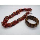 A 492ct Yellow Tiger's Eye stretchable bracelet and a Red Coral ,