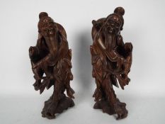 A pair of carved wood figures depicting fishermen, largest approximately 34 cm (h).