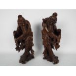 A pair of carved wood figures depicting fishermen, largest approximately 34 cm (h).