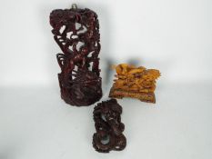 Three wooden carvings comprising a dragon with flaming pearl,