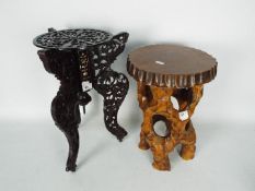 A carved wood and mother of pearl inlay, cast iron topped plant stand (41cm height) and one other.