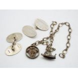 A white metal charm bracelet, stamped Sterling, with two charms,