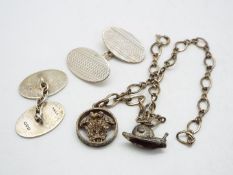 A white metal charm bracelet, stamped Sterling, with two charms,