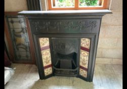 A Victorian cast iron fireplace with til