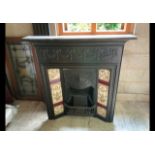 A Victorian cast iron fireplace with til