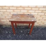 A vintage wooden school desk with hinged