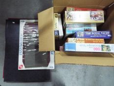 A collection of boxed jigsaw puzzles and