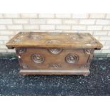 A storage chest with carved decoration,