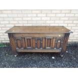 An oak coffer with carved detailing on c