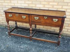 An oak, twin drawer sideboard measuring