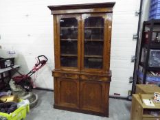 A glazed twin door library bookcase with