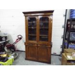 A glazed twin door library bookcase with