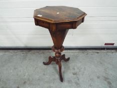 An octagonal topped sewing table with co