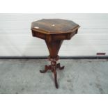 An octagonal topped sewing table with co