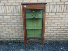 A mahogany display cabinet with inlaid d