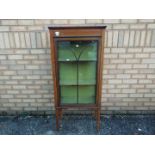 A mahogany display cabinet with inlaid d