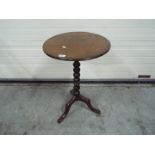 A circular topped side table with bobbin