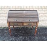 An oak cylinder roll top writing bureau,