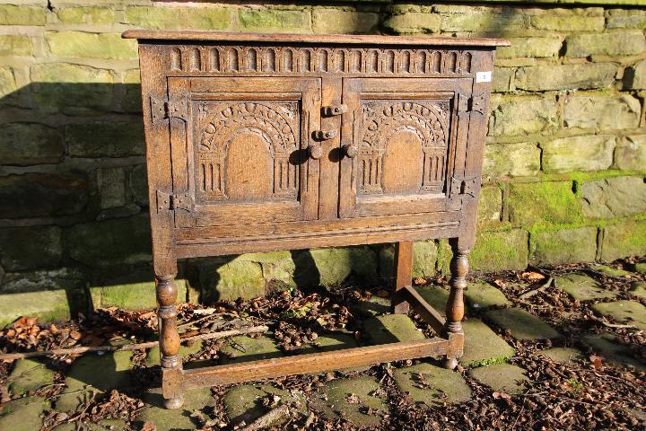 A small side cupboard with carved decora