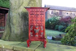 A small Chinese cabinet with a bank of s