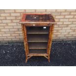 A bamboo framed display cabinet, the top