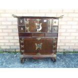 An altar style cabinet with brass mounts